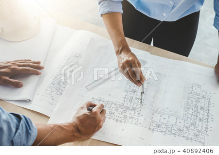 Hands of architect or engineer working on blueprint meeting for 40892406