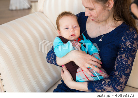 loving young mother holding her son indoors 40893372