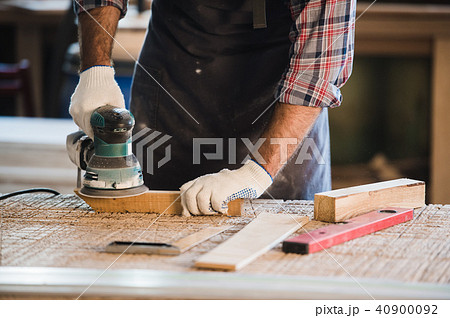 Worker grinds the wood of angular grinding machine 40900092