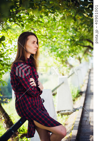 cute girl in a checkered dress at summer park 40901001