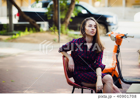 young attractive girl with beautiful smile wearing violet checkered dress and vintage old scooter young attractive girl with beautiful smile wearing violet checkered dress and vintage old scooter 40901708
