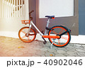 Modern two-wheeled bicycle indoors near color wall 40902046