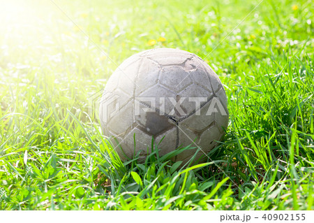 Old soccer ball on the green grass 40902155