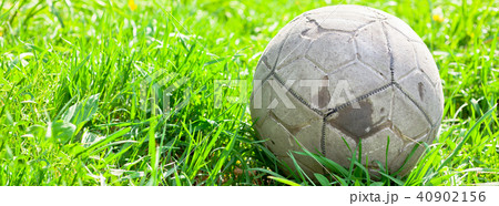 Old soccer ball on the green grass 40902156