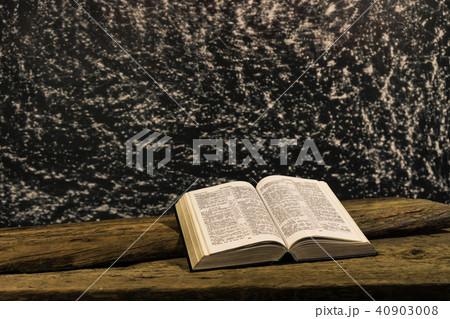 Bible on a old oak wooden table. Bible on a old oak wooden table. 40903008