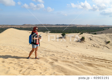 traveler holding camera at white sand dune desert traveler holding camera at white sand dune desert 40903191