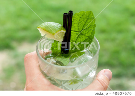 glass of mojito in female hand 40907670