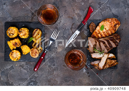 Fresh three types of grilled steak (chicken, pork, beef) on slate plate with herbs, tomato, juice Fresh three types of grilled steak (chicken, pork, beef) on slate plate with herbs, tomato, juice 40909748