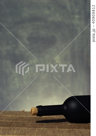 Glass of wine A black bottle of red wine on a wood 40909812