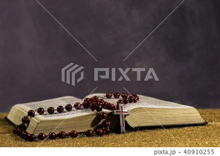 Bible and the crucifix on a gold table.  40910255