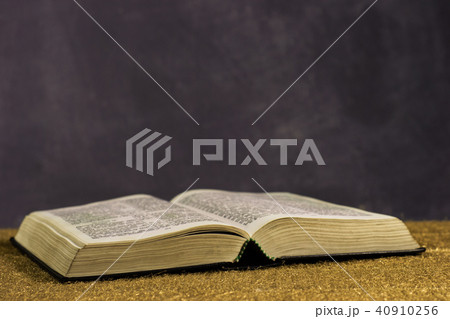 Bible and the crucifix on a gold table. Bible and the crucifix on a gold table. 40910256
