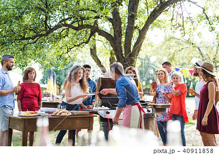 Family celebration or a barbecue party outside in the backyard. Family celebration or a barbecue party outside in the backyard. 40911858