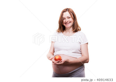 Happy pregnant woman holds a red apple in her hands 40914633
