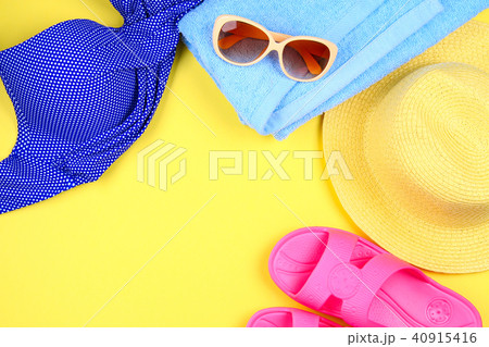 Slippers, swimsuit bikini, towel, hat and sunglass Slippers, swimsuit bikini, towel, hat and sunglass 40915416