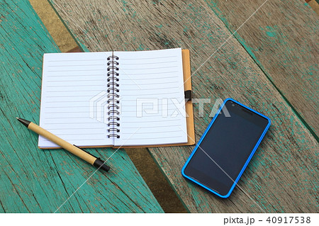 notebook with pen and mobile phone on the green ta notebook with pen and mobile phone on the green ta 40917538