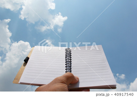 two page notebook in hand on the background of sky two page notebook in hand on the background of sky 40917540