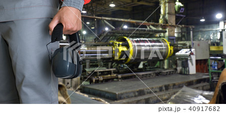 Worker with protective headphone 40917682