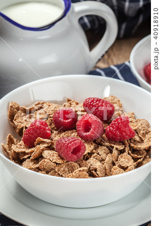 Tasty breakfast with milk and raspberries. Tasty breakfast with milk and raspberries. 40918910