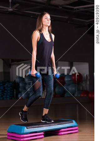 Sporty woman practice on step platform in gym Sporty woman practice on step platform in gym 40919390