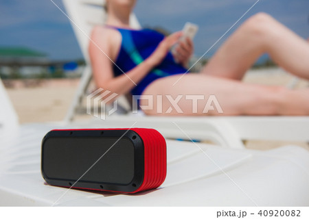 Portable speaker and female with mobile phone Portable speaker and female with mobile phone 40920082