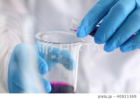 A male chemist holds test tube of glass in 40921369