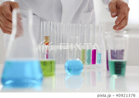 A male chemist holds test tube of glass in A male chemist holds test tube of glass in 40921376