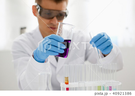 A male chemist holds test tube of glass in A male chemist holds test tube of glass in 40921386