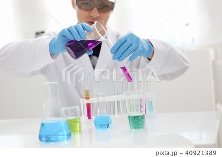 A male chemist holds test tube of glass in A male chemist holds test tube of glass in 40921389