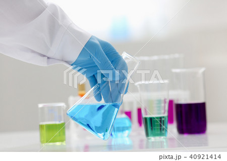 A male chemist holds test tube of glass in 40921414