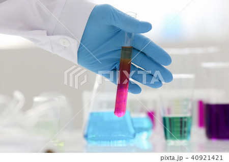 A male chemist holds test tube of glass in 40921421