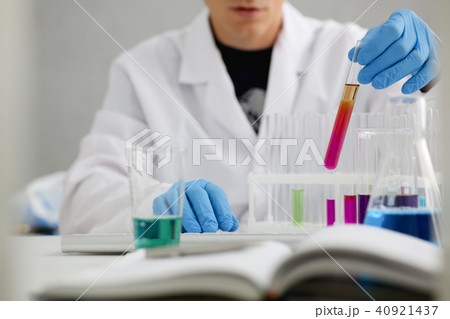 A male chemist holds test tube of glass in A male chemist holds test tube of glass in 40921437