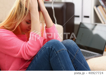 Unhappy lonely depressed woman sitting on the couch 40927724