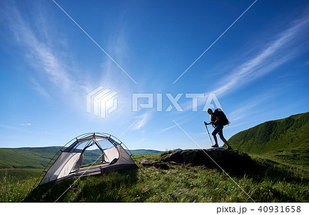 Silhouette of woman climber near camping against blue sky in the morning 40931658