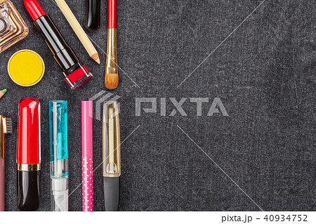 set of decorative cosmetics on a black textile 40934752