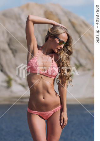 Girl on the sandy beach in a bathing suit 40937600