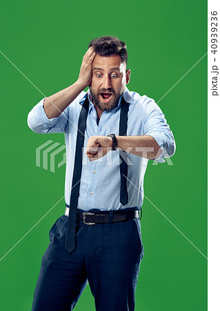 Handsome businessman checking his wrist-watch Isolated on white background Handsome businessman checking his wrist-watch Isolated on white background 40939236