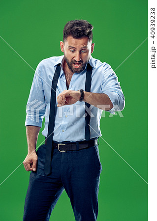 Handsome businessman checking his wrist-watch Isolated on white background Handsome businessman checking his wrist-watch Isolated on white background 40939238