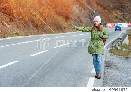 Woman tourist hitch-hiking on the road Woman tourist hitch-hiking on the road 40941832