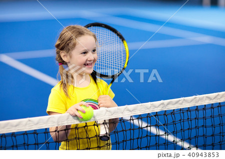 Child playing tennis on indoor court 40943853
