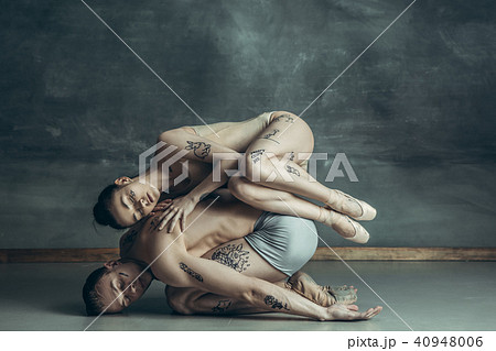 The young modern ballet dancers posing on gray studio background 40948006