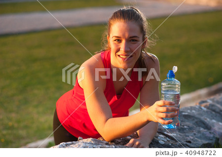 Sportswoman Resting with Water During Workout 40948722