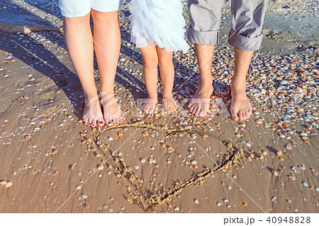 No face family of three standing near drawn heart 40948828