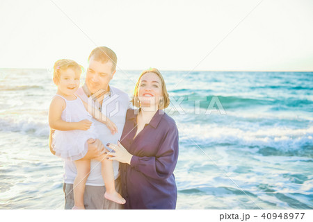 Happy family of three having fun  on the beach 40948977