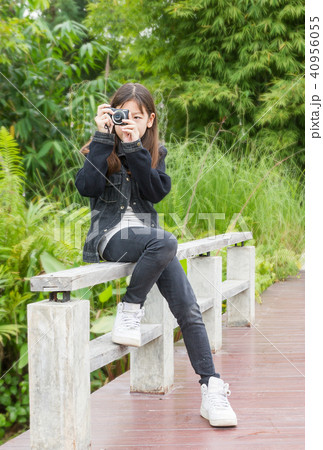 Asian young girl taking photos outdoors 40956055