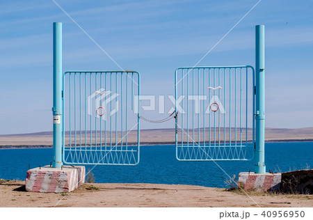 iron gate to the pond, closed with a chain iron gate to the pond, closed with a chain 40956950
