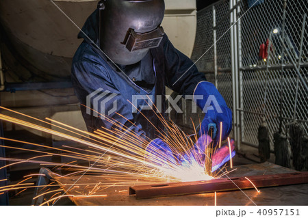 Industrial worker is welding assembly part 40957151