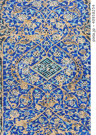 Remains of decorated blue mosaic tiles on wall  40958254