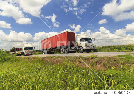 Red truck on the highway under the blue sky 40960438