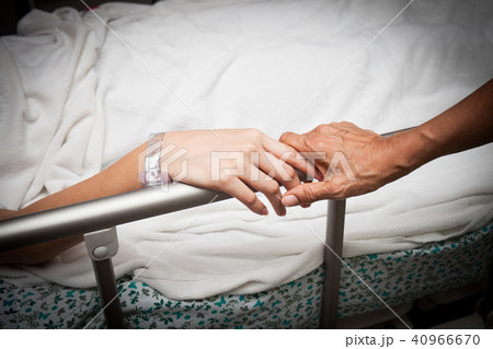 An old wrinkled hand touches and holds young hand An old wrinkled hand touches and holds young hand 40966670