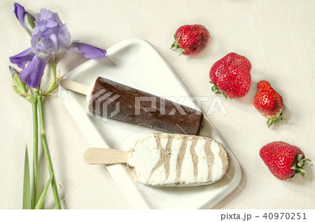 Two kinds of ice cream on a stick with chocolate Two kinds of ice cream on a stick with chocolate 40970251